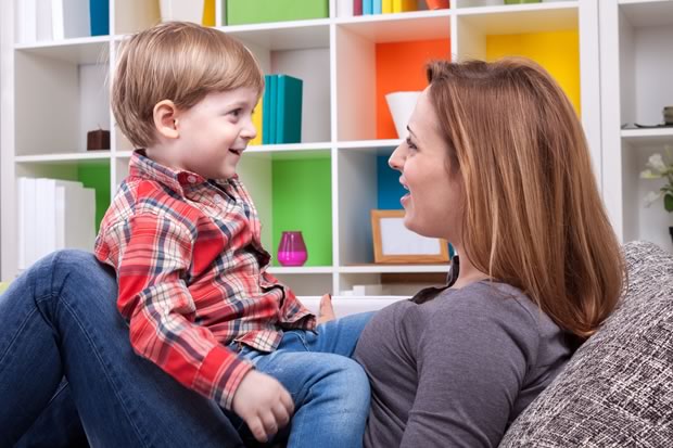 autistic child and therapist playfully making faces with each other