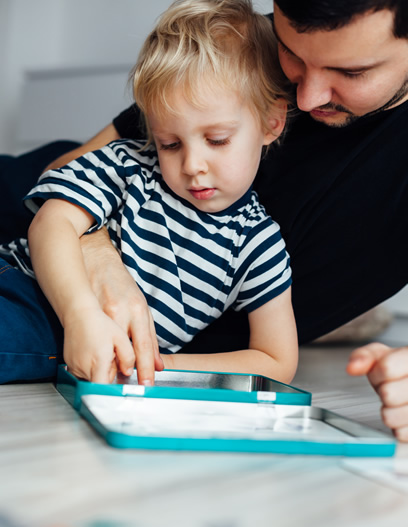 father and son with autism playing a board game